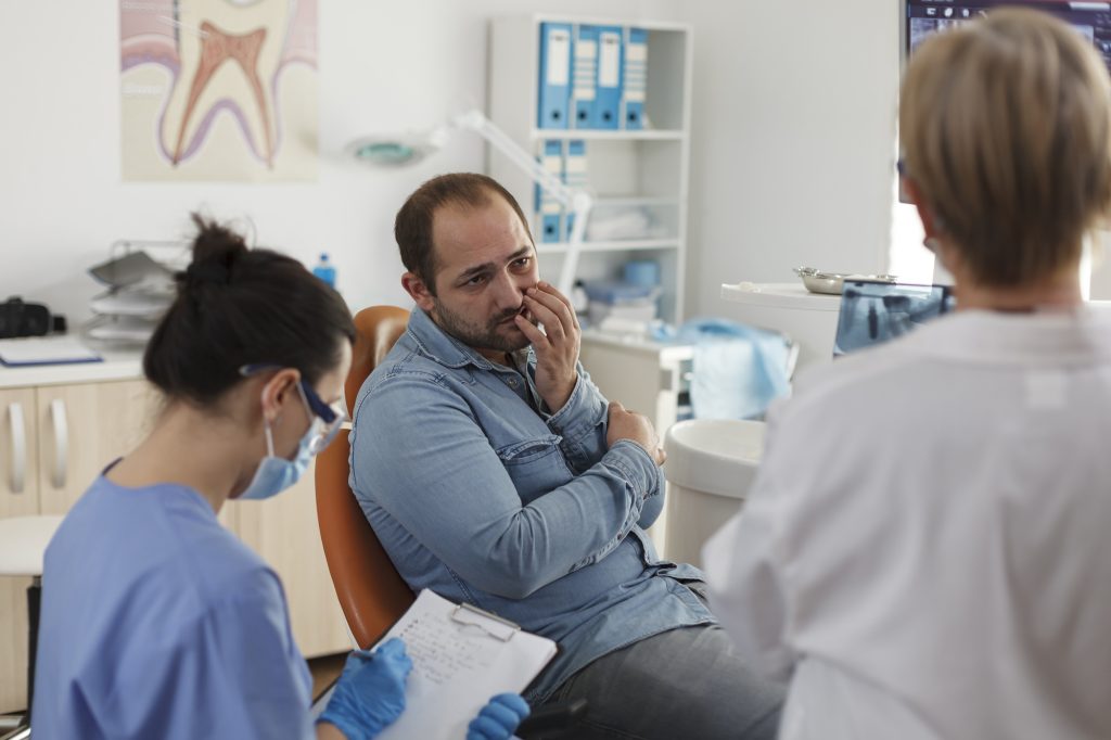 Dentist in Bethlehem, PA examining a patient for signs of dental problems