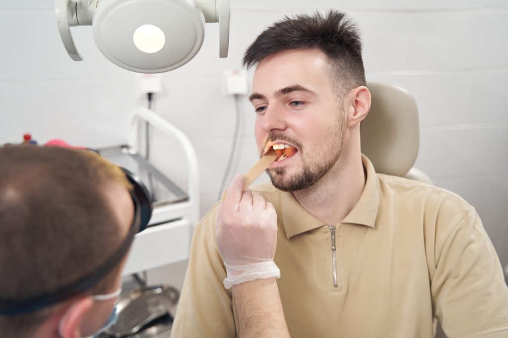 dentist examining food impaction between teeth