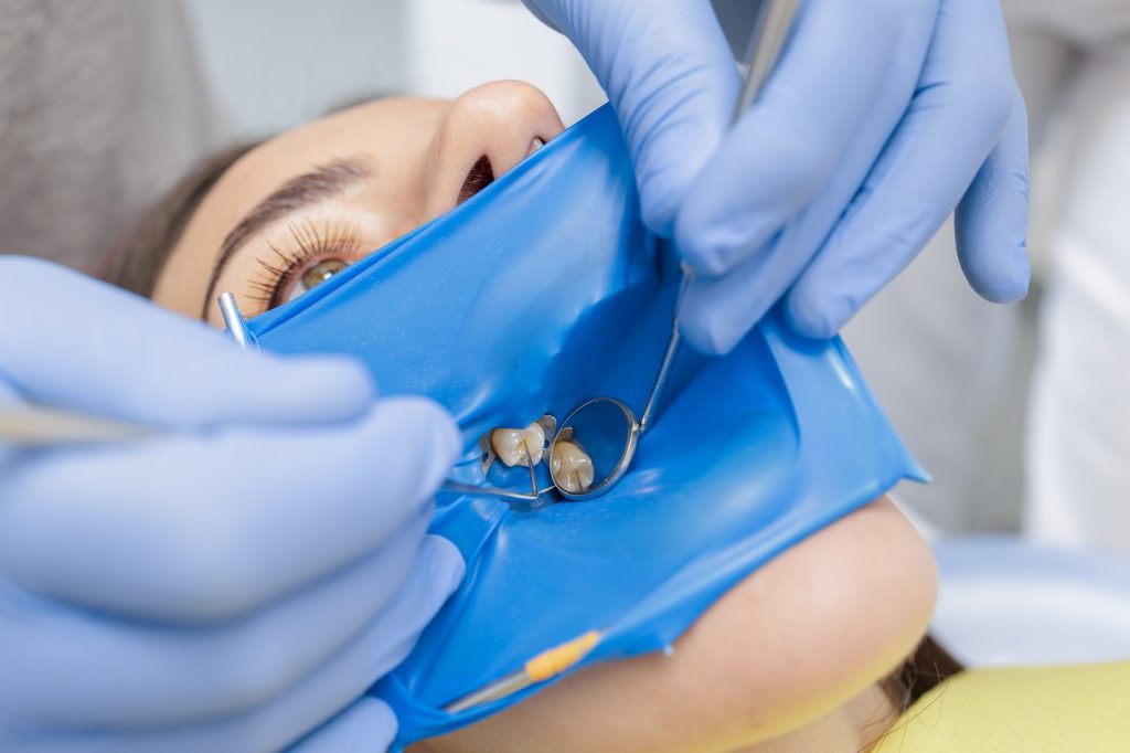 dentist examining an old dental crown in Bethlehem PA